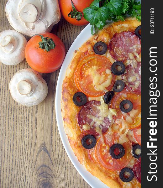 Pizza with tomato, sausage, mushrooms, cheese, olives ( close up)