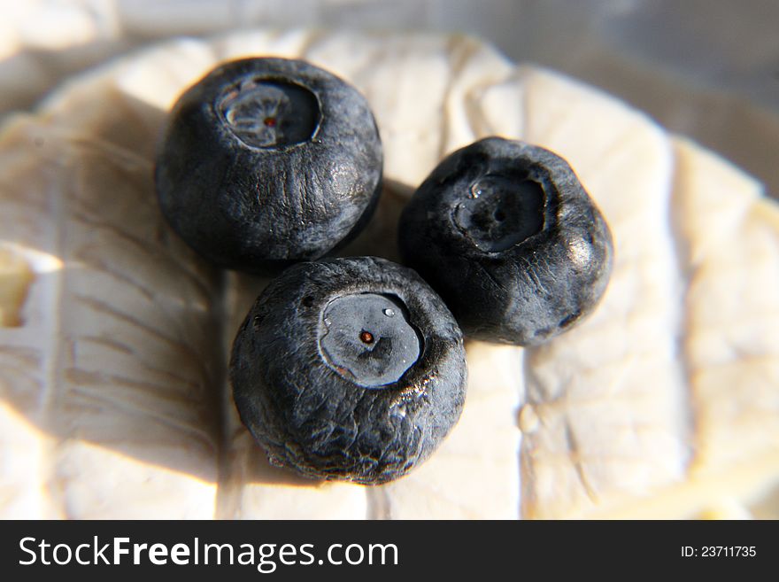 Three berries of a bilberry and cheese Brie