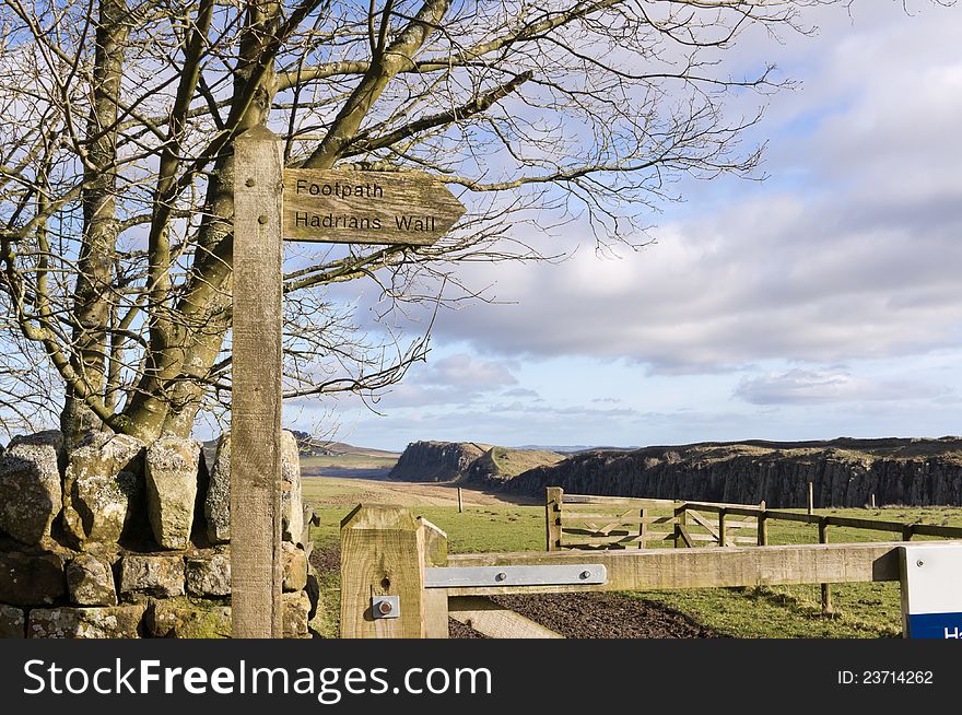 Sign post to Hadrians Wall with Steel Rigg and Crag Lough behind. Sign post to Hadrians Wall with Steel Rigg and Crag Lough behind