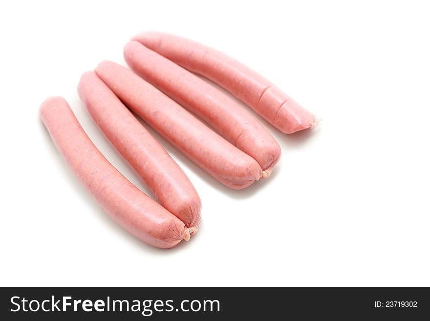 A few fresh sausages are on a white background. A few fresh sausages are on a white background