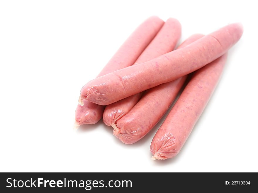 A few fresh sausages are on a white background. A few fresh sausages are on a white background