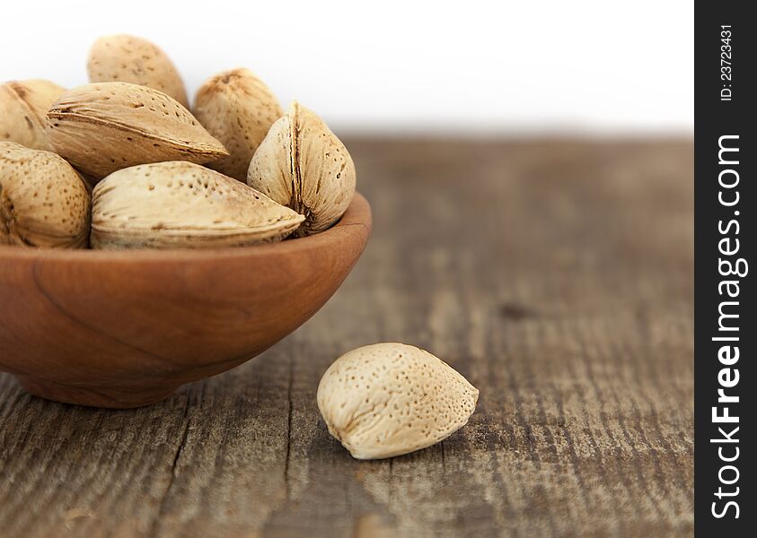 Almonds. Pile in the plate. Shallow focus