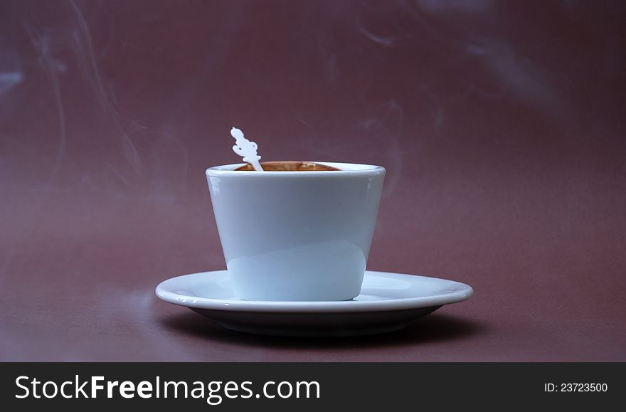 Pic  cup of coffee on brown background. Pic  cup of coffee on brown background