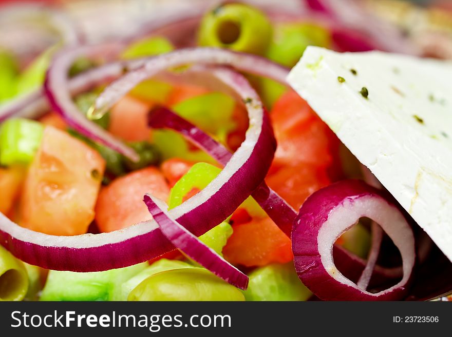 Fresh salad with cheese, onion, cucumber, tomato and olives