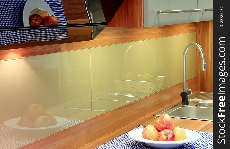 A beautiful reflections in new kitchen with apples for decoration. A beautiful reflections in new kitchen with apples for decoration.