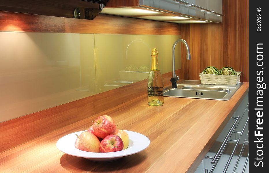 Beautiful interior of kitchen with apples for decoration, a bottle of vine and vegetables. Beautiful interior of kitchen with apples for decoration, a bottle of vine and vegetables.
