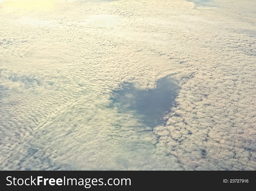 Fluffy clouds and in the middle a heart contour. Fluffy clouds and in the middle a heart contour