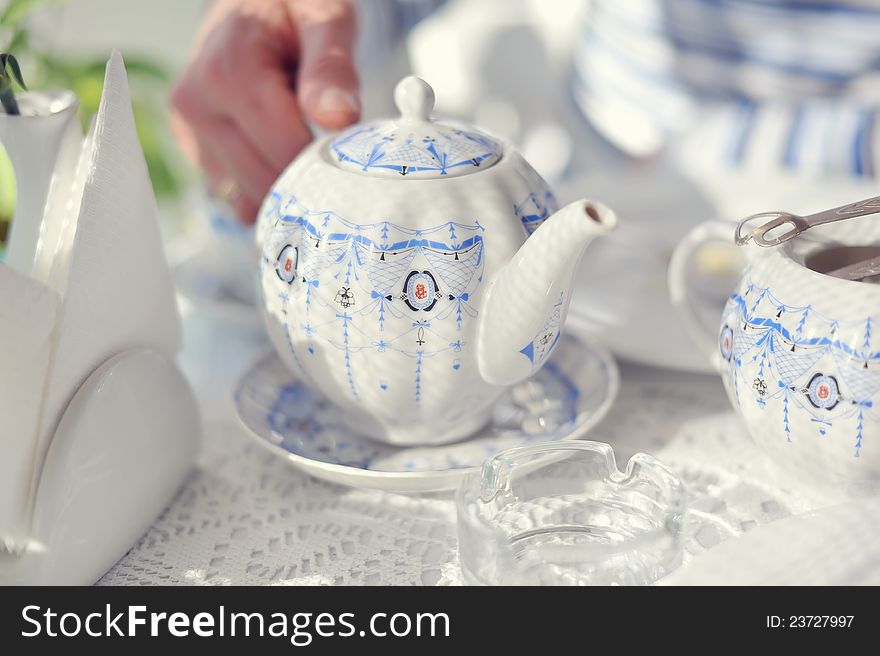 Color porcelain cup with tea and a saucer