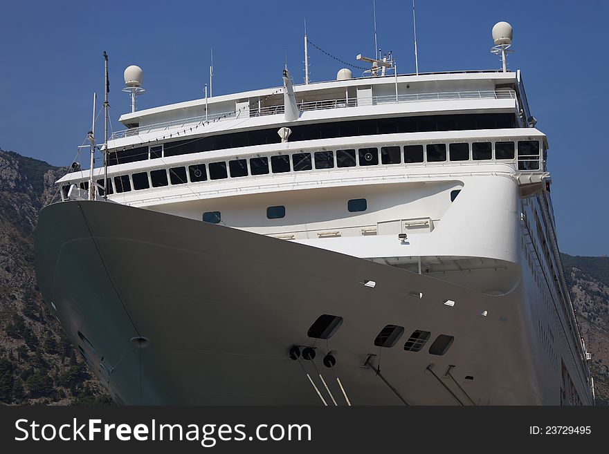 Modern white cruise ship bow at dock