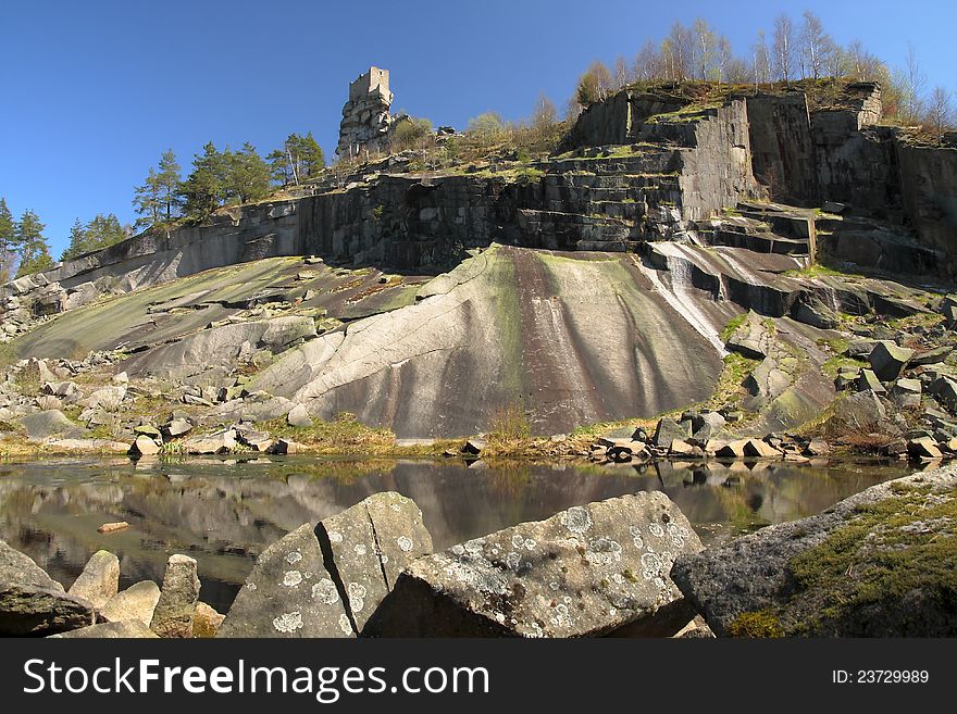 Old big granite quarry with pond and a castle ruin flossenburg above. Old big granite quarry with pond and a castle ruin flossenburg above