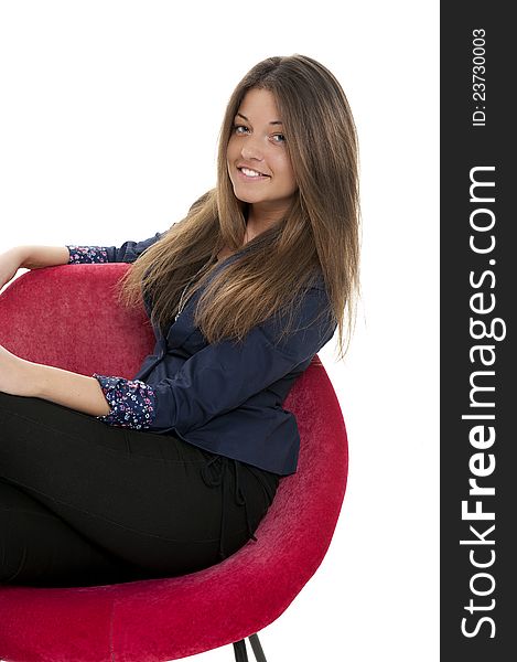 Young woman on the red couch, studio shot. Young woman on the red couch, studio shot