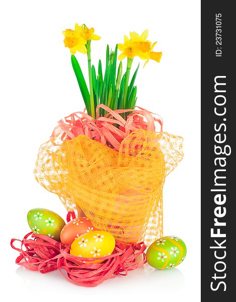 Easter eggs and spring yellow narcissus (daffodil) in flower pot with bright decoration isolated on white background. Easter eggs and spring yellow narcissus (daffodil) in flower pot with bright decoration isolated on white background