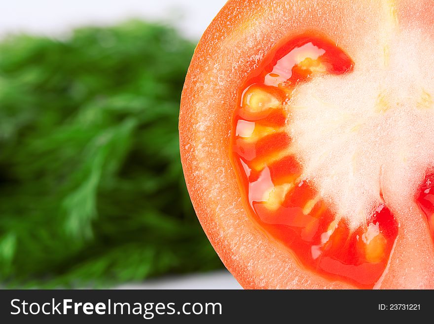 Closeup tomato with green dill background