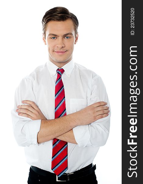 Cute young professional male standing with folded arms against white background. Cute young professional male standing with folded arms against white background