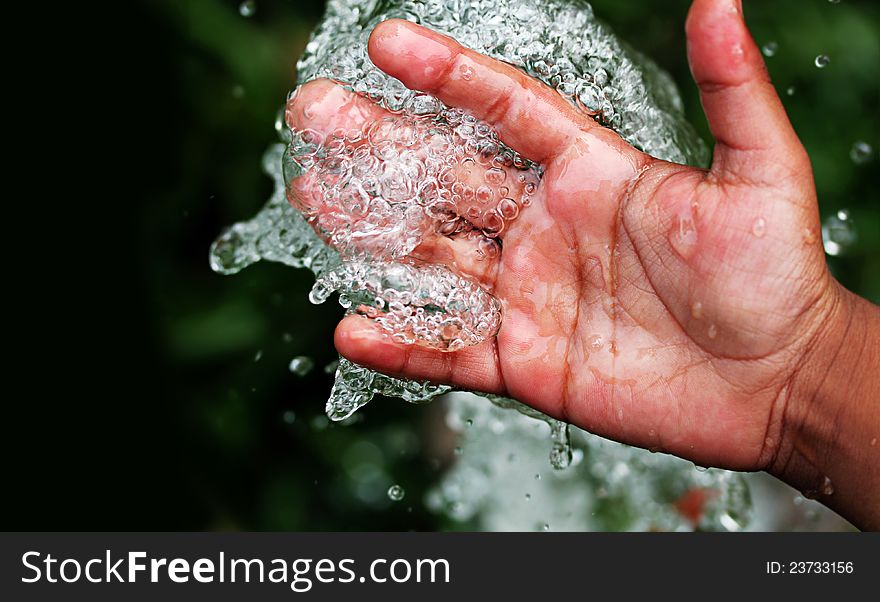 Fresh pure bubbling water splashing on hand