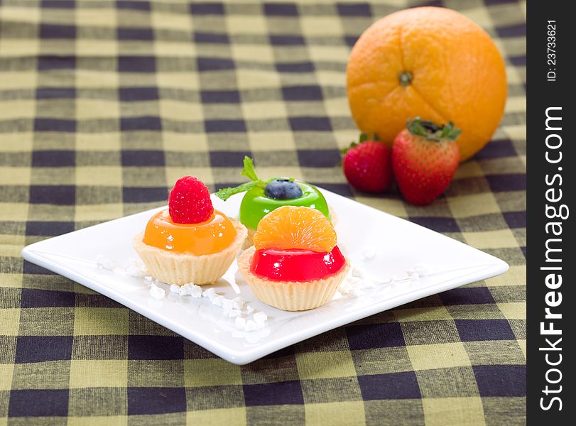 Jelly cupcake decorates with raspberry orange and blueberry. Jelly cupcake decorates with raspberry orange and blueberry