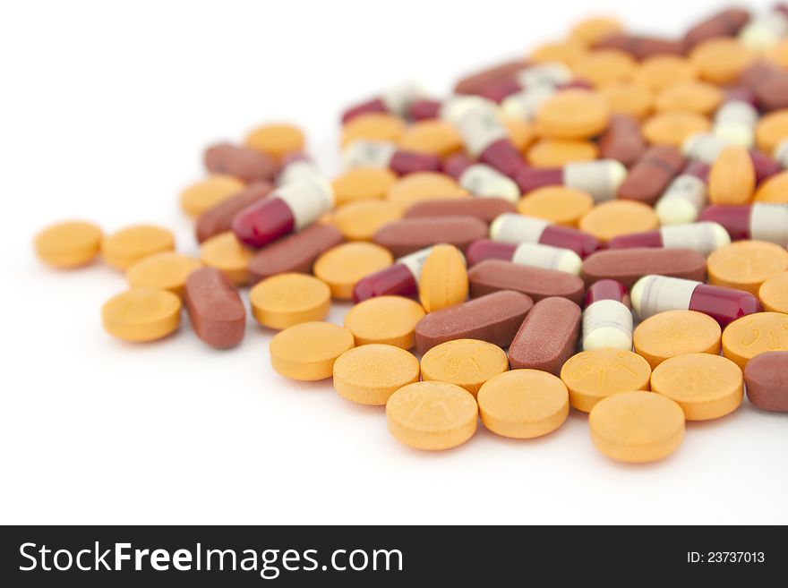 Colorful tablets with capsules isolated on white. Colorful tablets with capsules isolated on white