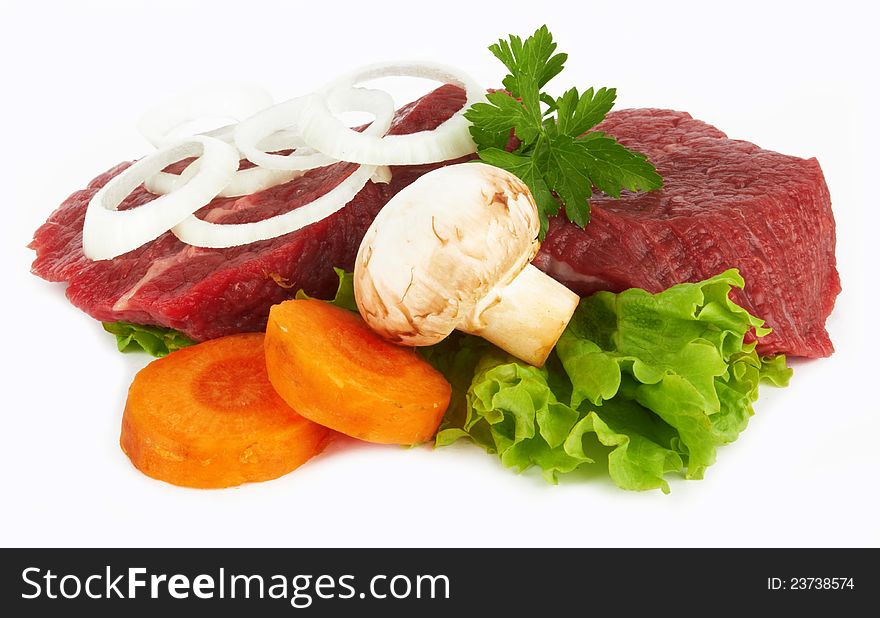 Raw meat and vegetables on white