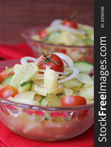 Salad with potatoes, cherry tomatoes, onion, cucumber and pickles. Salad with potatoes, cherry tomatoes, onion, cucumber and pickles