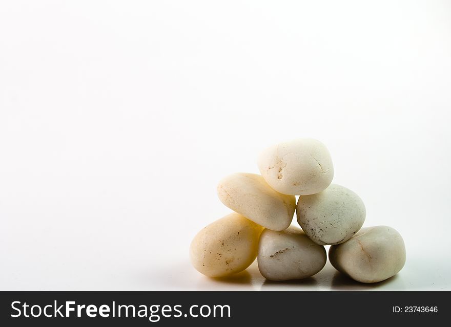 Stacked white stones on a white backgrounds. Stacked white stones on a white backgrounds