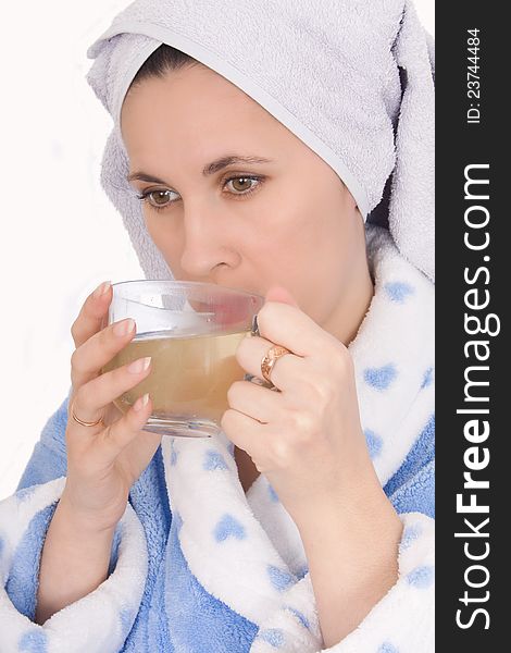 Happy woman in bathrobe drinking cup tea. Happy woman in bathrobe drinking cup tea