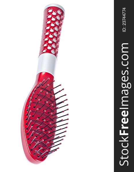 Close up of a red hair brush isolated on white.