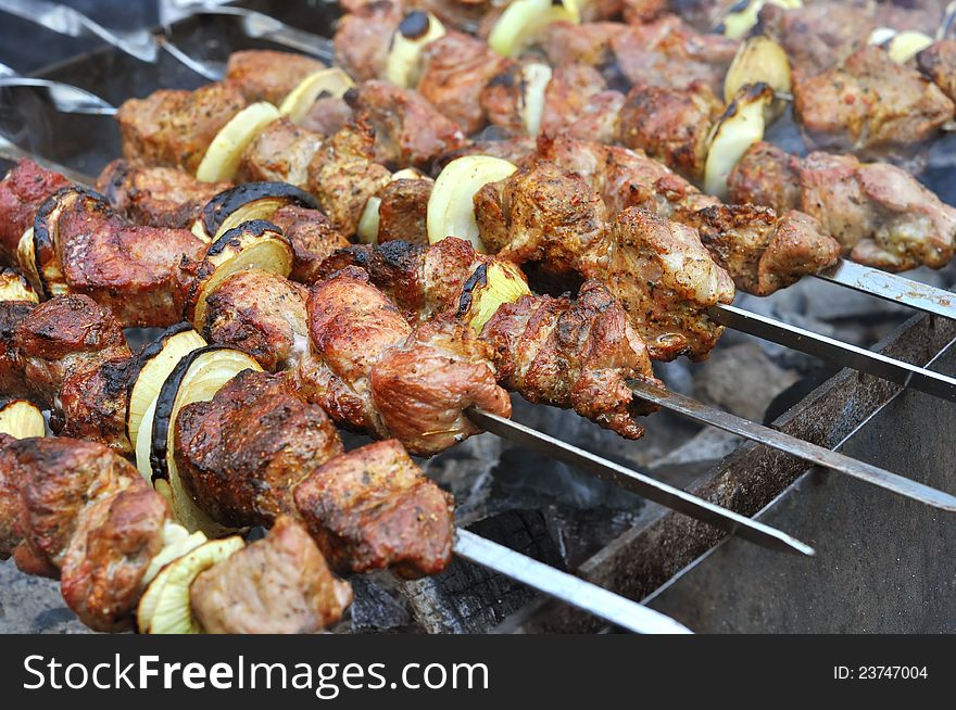 Kebab prepares on the fire outdoors. Kebab prepares on the fire outdoors