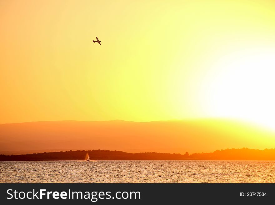 Sunset on the lake with airplane flight. Sunset on the lake with airplane flight