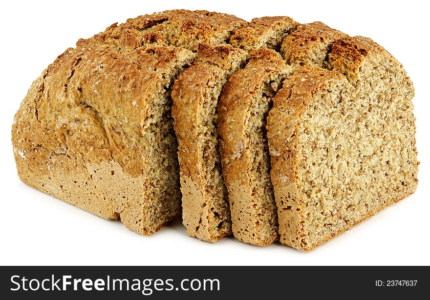 A loaf of bread with three slices on a white table