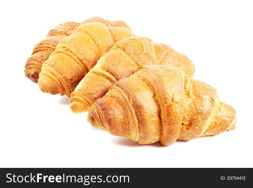 Four french croissants on white background