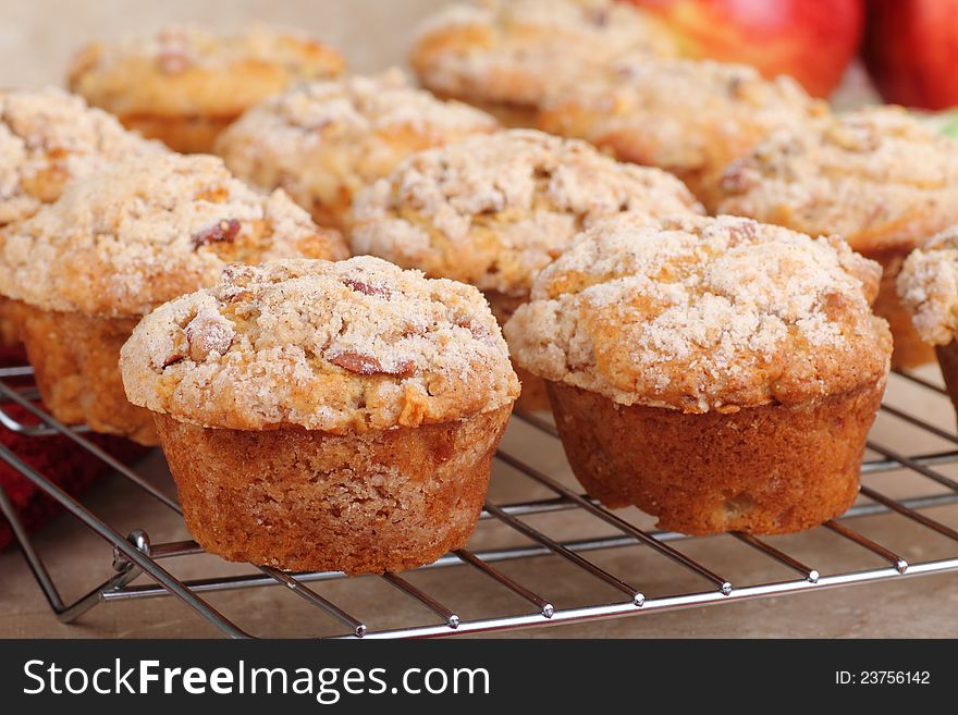 Closeup of apple muffins cooling on a rack