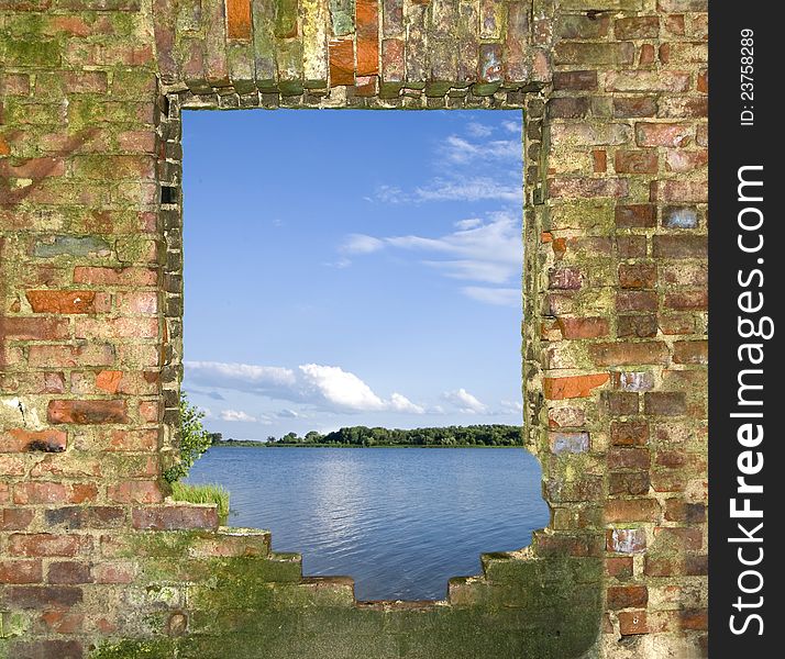 Window in the broken brick wall with a kind on the river. Window in the broken brick wall with a kind on the river
