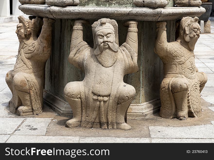 Three man chinese stone sitting on ground .