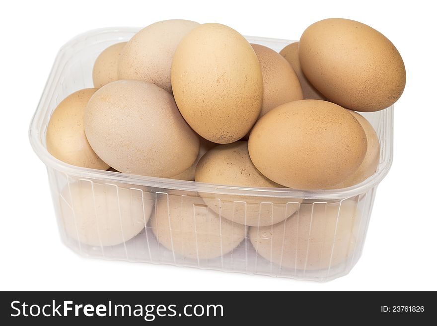 Chicken eggs in a container on a white background.