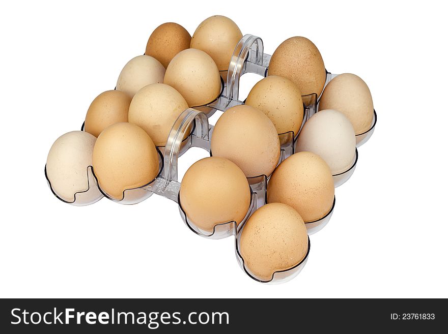 Eggs in a plastic container on a white background, close-up shot. Eggs in a plastic container on a white background, close-up shot.