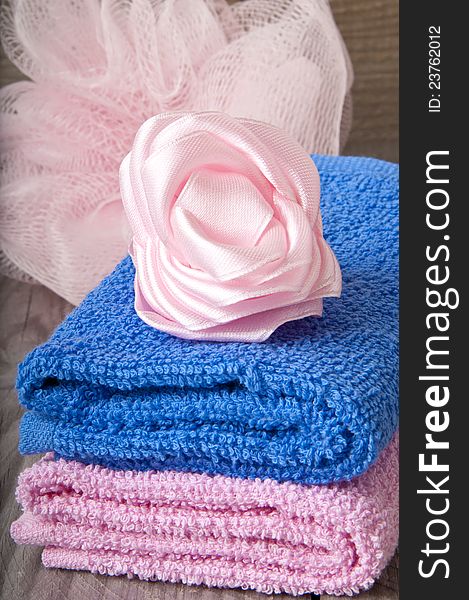 Pink and blue bath spa accessory over a wooden background