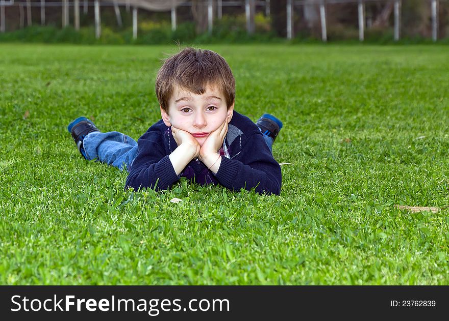 A shot of 5 year old cute child lying on grass