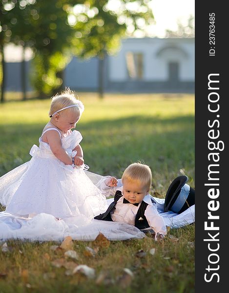 Children dressed as bride and groom play with each other