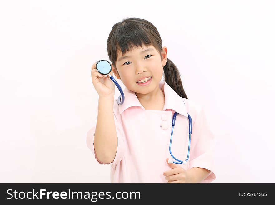 A young asian girl playing dress up as a nurse. A young asian girl playing dress up as a nurse