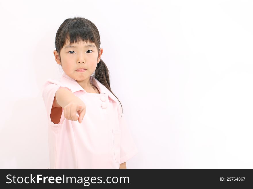 Portrait of asian happy little girl nurse pointing. Portrait of asian happy little girl nurse pointing