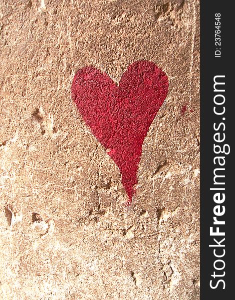 Red heart drawn over brown textured wall. Red heart drawn over brown textured wall
