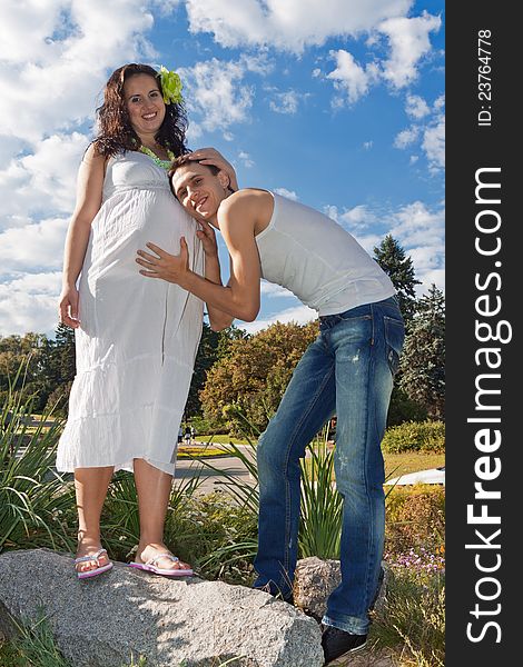 Pregnant couple resting in the park