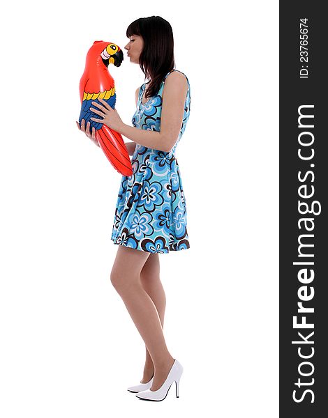 Woman having fun with inflatable parrot