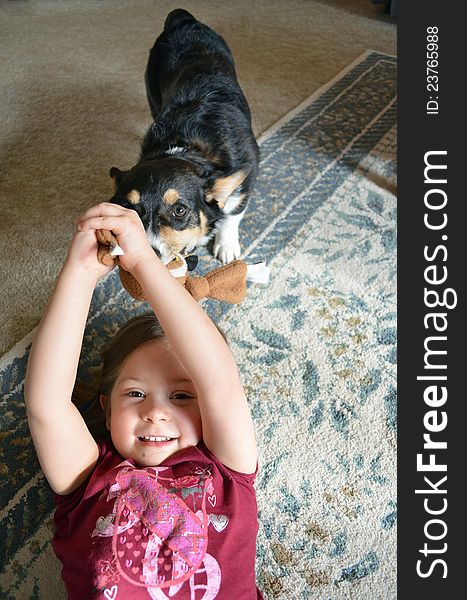 A young girl plays with her dog. A young girl plays with her dog