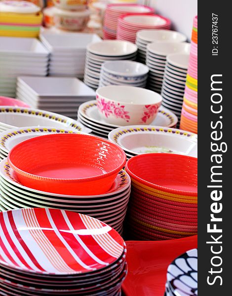 Colorful melamine, ceramic, china clay and plastic bowls arranged for sale in a market. Colorful melamine, ceramic, china clay and plastic bowls arranged for sale in a market