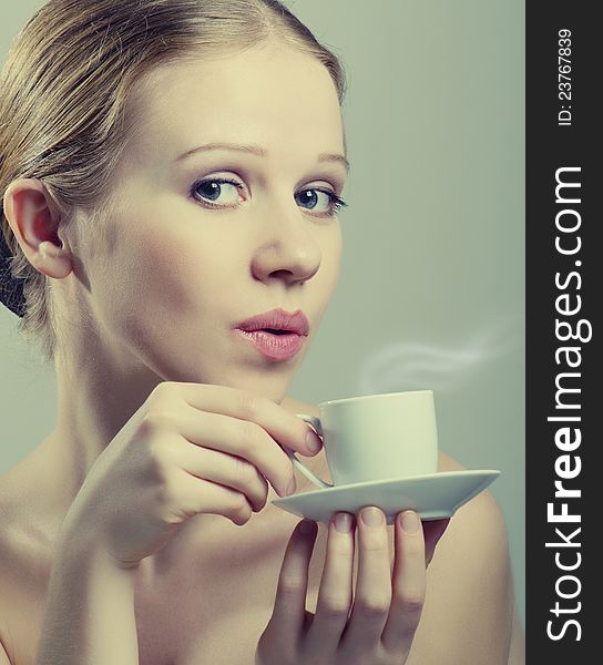 Beautiful girl enjoying  cup of coffee