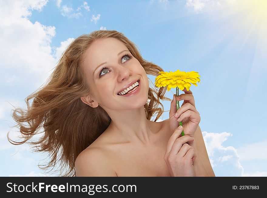 Beautiful girl with flowing hair, yellow gerbera