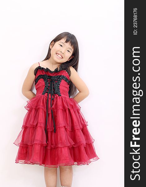 Little asian girl wearing dress, with hands at her back. Little asian girl wearing dress, with hands at her back
