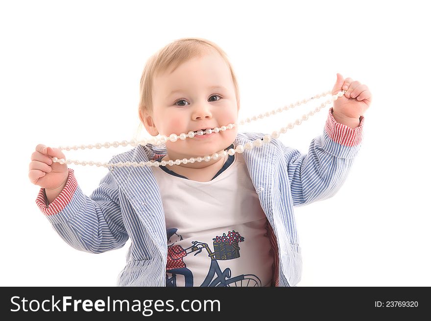 Little girl with pearl beads in his hands and mouth on the white backgraund. Little girl with pearl beads in his hands and mouth on the white backgraund