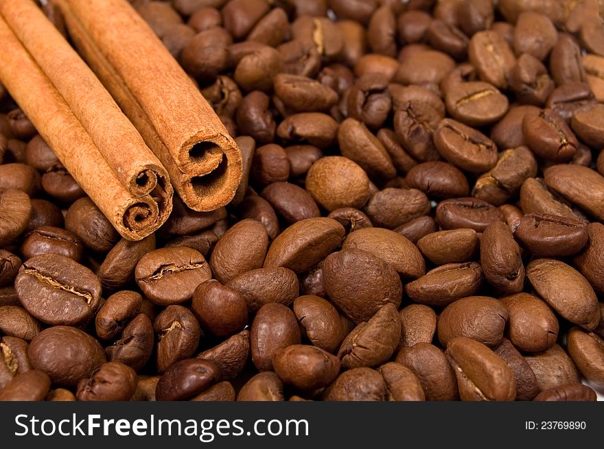 Background with coffee beans and canella sticks